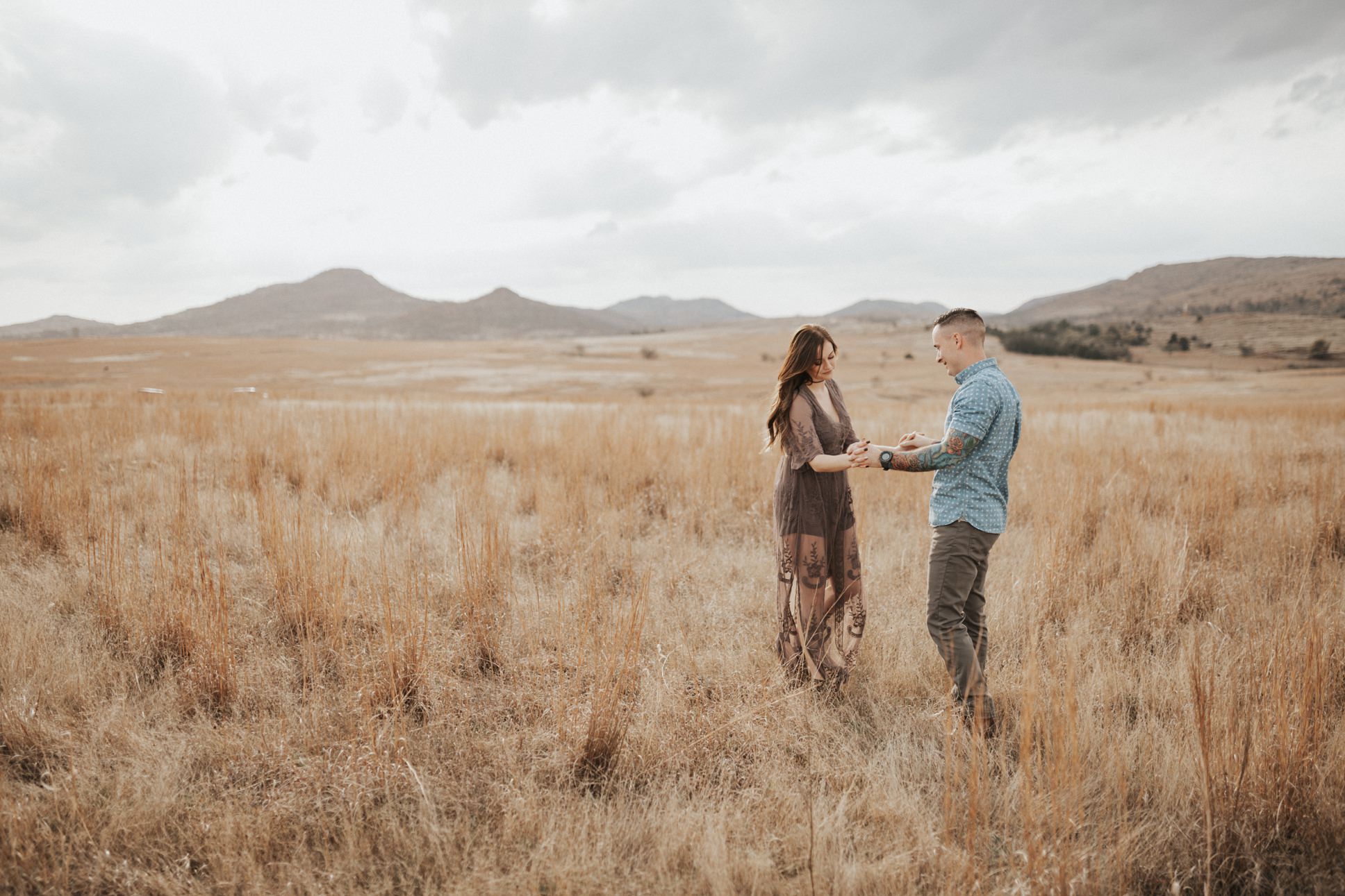 A couple holding hands during their engagement session at the Wichita Mountains.