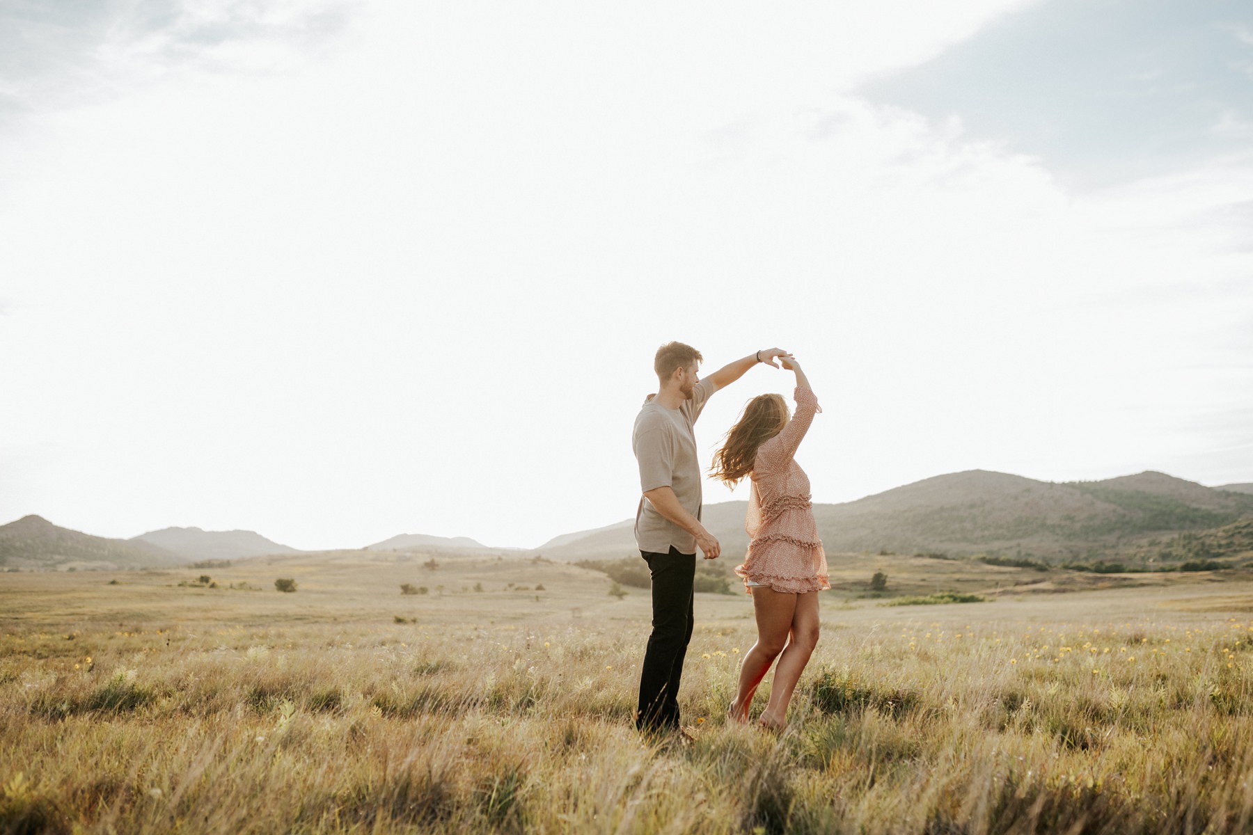 A couple dancing in an open field at the Wichita Mountains.