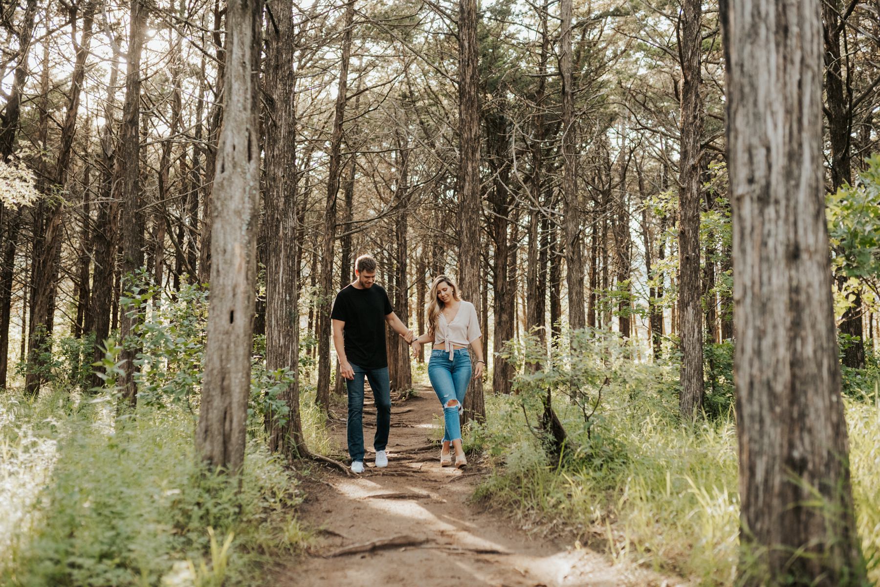 A couple walking in the Parallel Forest in the Wichita Mountains.