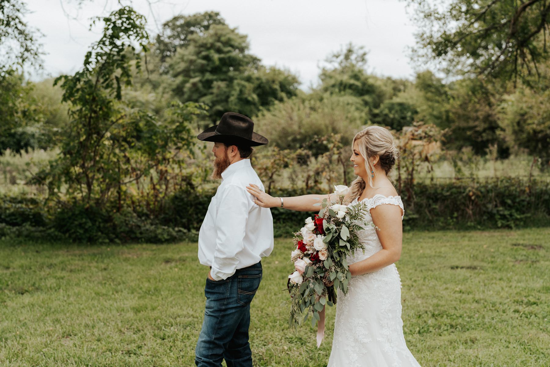 A bride and grooms first look at their wedding at The Barn at Belamour in Springfield, MO.